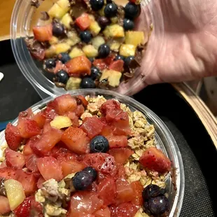 Açaí bowl with mushy strawberries (and food attached to the lid).