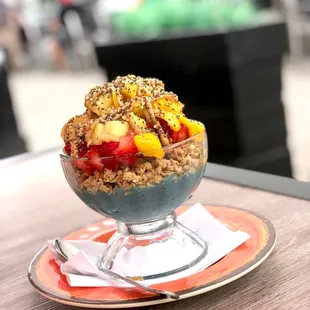 Spurlina base, gf granola, pineapple, strawberries, mango, chia seeds, and hemp seeds.