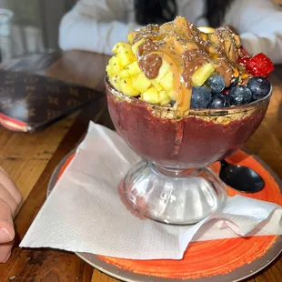 Design a Bowl: Açaí  Regular granola  Strawberry&apos;s, pineapples, blueberries  Nutella, peanut butter, honey, chia seeds