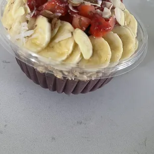 a cupcake with bananas, strawberries, and almonds