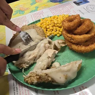 Chicken fried chicken with onion rings and buttered corn