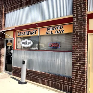a brick building with a sign that says breakfast served all day