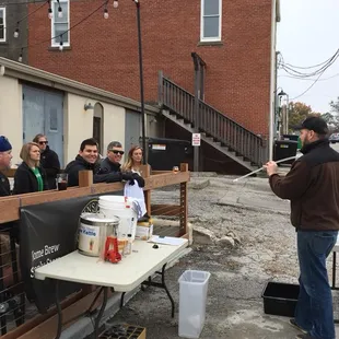 Brian F leading a beginner brewing class on the patio.