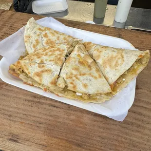 Chicken quesadilla added sour cream, salsa verde, and pickled onions