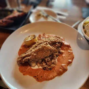Blackened Fried Catfish  Cornmeal breaded, stewed black eyed peas, braised greens, pickled onion &amp; cucumber salad