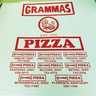 a large pizza box with a variety of toppings