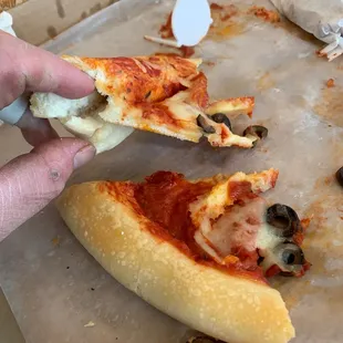 Cheese less pizza with folded crust. Yuk, disgusting and should be embarrassing