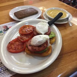 Gramm&apos;s Egg Benedict, with corn muffin, grilled tomato and  side of scrapple.