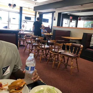 a man sitting at a table with a plate of food