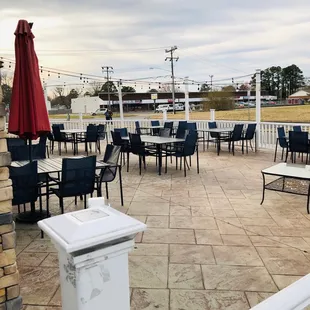 a patio with tables and chairs