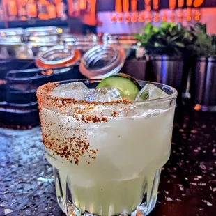 a margarita with a lime garnish on the rim