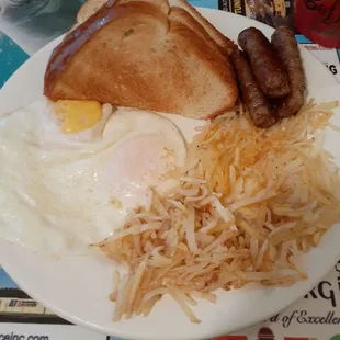 Eggs over easy, hashbrowns, sausage, and toast