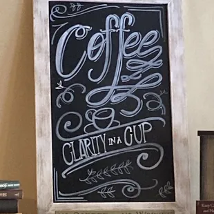 a chalkboard sign on a shelf