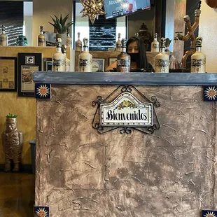 a woman behind a counter in a restaurant