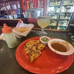 a plate of quesadillas and a drink