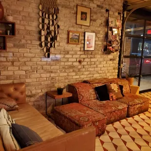 a living room with a brick wall