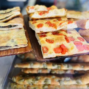 a variety of flatbreads in a display case