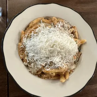 a bowl of pasta with parmesan cheese