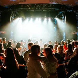 a couple dancing in front of a crowd