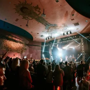 a crowd of people watching a concert