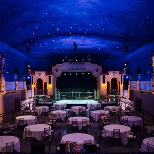 Churrigueresque atmospheric theater set in banquet mode with stage.