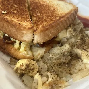 Breakfast sandwich with crispy bacon, extra cheese, home fries with cheese and onion, side of sausage gravy to go. So good!!!!!