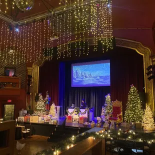 stage with christmas trees and presents
