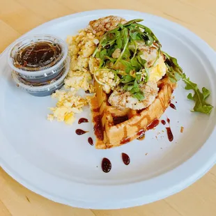 Half waffle with scrambled eggs, balsamic glaze and arugula