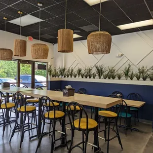 the interior of a restaurant with tables and chairs