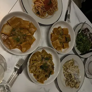 a variety of pasta dishes on a table