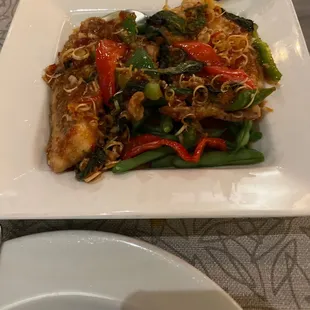 Fried talapia with green beans and peppers in a sweet basil sauce.