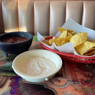 a bowl of chips and a bowl of dip