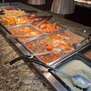 a variety of food in a buffet
