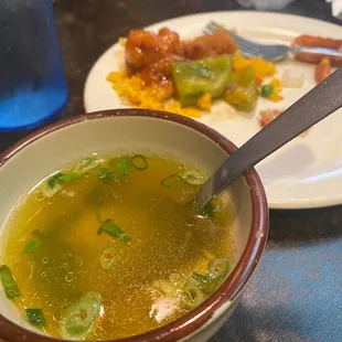 a bowl of soup and a plate of food