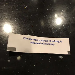 a piece of paper with a note saying the one who is afraid of making is ashamed of learning