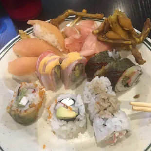 a plate of sushi and french fries