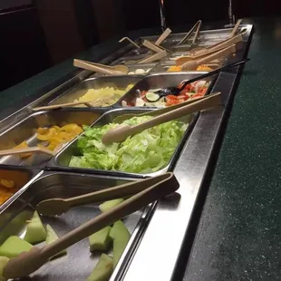 a variety of salads in a buffet