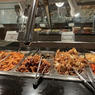 a variety of food in a buffet