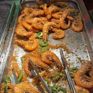 a tray of cooked shrimp and vegetables