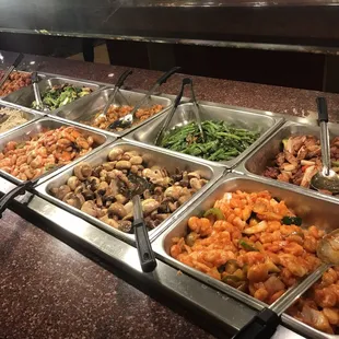 a variety of food in a buffet