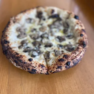 a small pizza on a wooden table