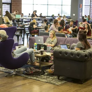a large group of people sitting in a lounge area