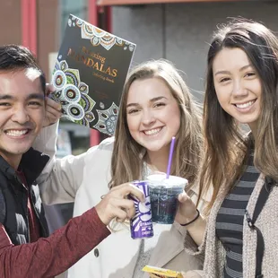 a group of people holding up drinks