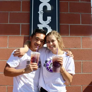 two people standing in front of a building
