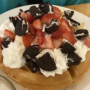 Waffle with ice cream, Oreos, strawberries and whipped cream