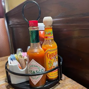 a tray of hot sauces and condiments
