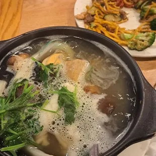 Mongolian Hot Pot, with mushrooms, basil, baby clams, mussels, and congee