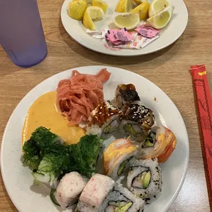 a plate of sushi and a glass of water