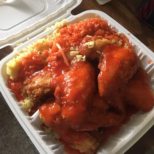 4 wing combo with fried rice and mumbo sauce all over.