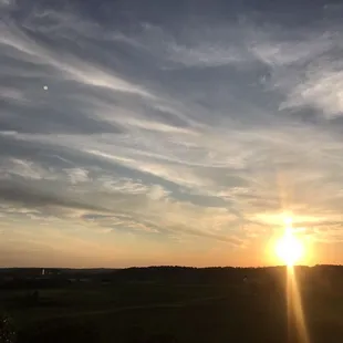 the sun setting over a field
